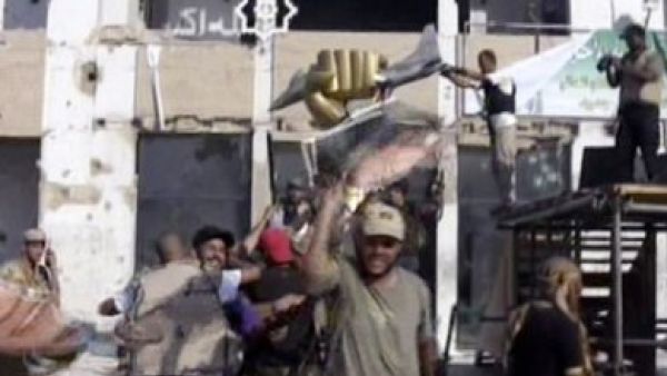 The triumphant fist of Gaddafi is now held up in rebel triumph against the falling leader believed to be hiding in the heavily fortified luxury tunnels built in the '80s. Other rebels stamped on a gold bust of the dictator's head. 