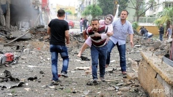 An injured woman is carried to safety after the car bomb in Reyhanli earlier this month. AFP