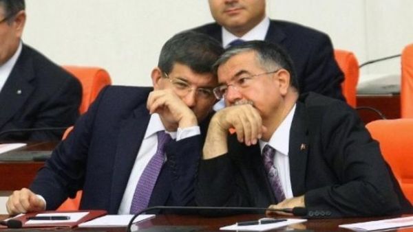 Turkish foreign minister, Ahmet Davutoglu cozies up to his defence minister during a debate on Syria