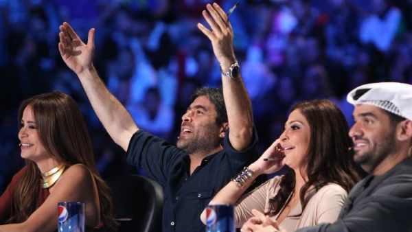 Wael and Elissa share a joke on-screen.