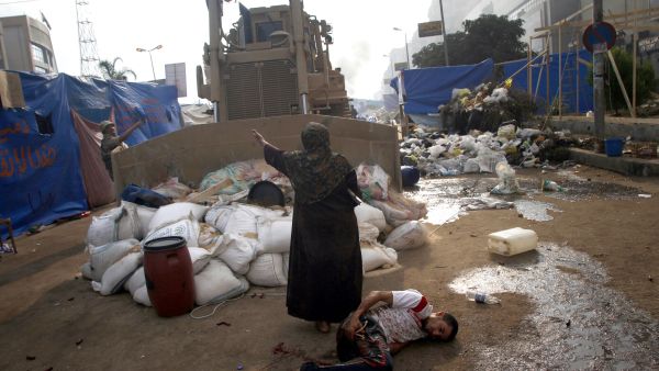 An Egyptian woman tries to stop a military bulldozer (AFP/MOHAMMED ABDEL MONEIM) An Egyptian woman tries to stop a military bulldozer (AFP/MOHAMMED ABDEL MONEIM)