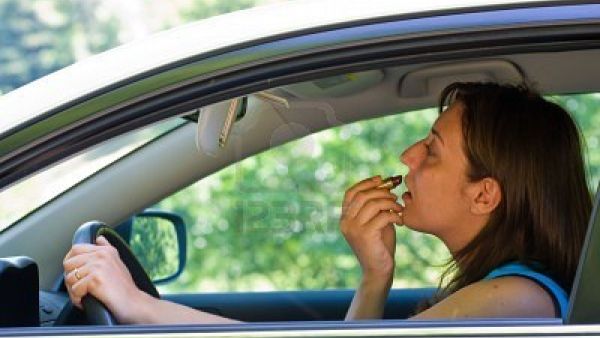 Image source: the News Tribe. Fined for applying make-up mid-driving.