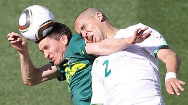 Algerian footballer clashes with an opponent on the field