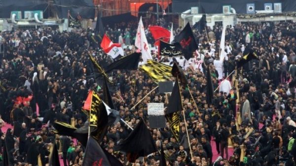 Shiite pilgrims gather in Karbala Tuesday to commemorate the anniversary Imam Hussein's death (Ali al-Saadi/AFP)
