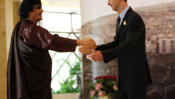 Both leaders Al-Assad and Gaddafi have seen better times. Here, they meet and greet at the Arab Summit at Damascus, 2008.