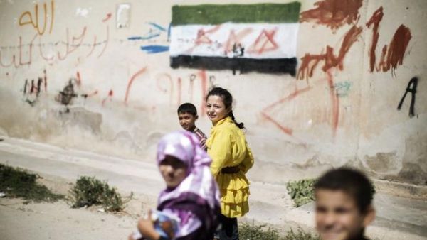 Children walk home from an improvised school in Azaz (AFP)