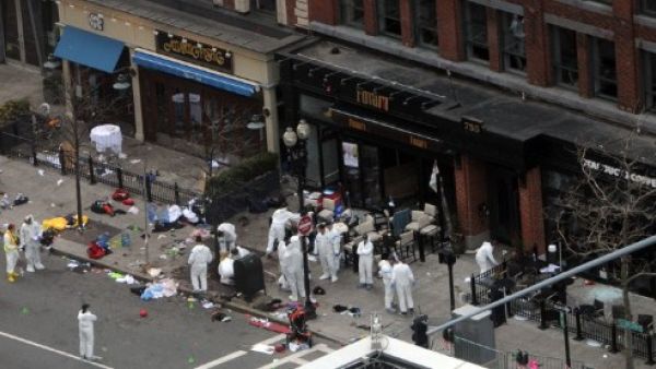 Investigators in white jumpsuits work the crime scene on Boylston Street following Monday's bomb attack at the Boston Marathon. (Photo: Darren McCollester/Getty Images/AFP)