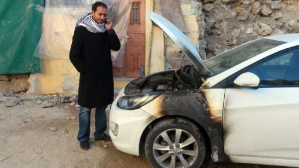 Israeli settlers burnt two Palestinian cars near Nablus (Jaafar Ashtiyeh/AFP)