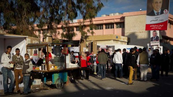 Coffee vendors try to profit from election day, pitching up in a busy polling station in central Amman
