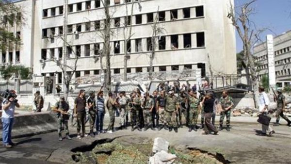 Soldiers look on as Damascus explosion leaves ground in ruins
