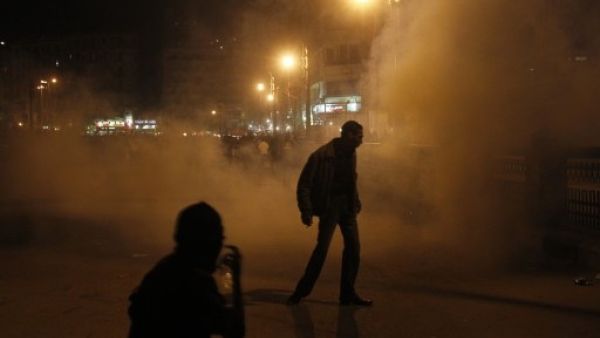 Egyptian protesters walk away after riot police used tear gas during a protest in Tahrir Square on January 24, 2012 in Cairo. (Photo: MOHAMMED ABED / AFP)