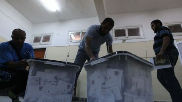 Egyptian election officials open ballot box before counting ballots at a polling station in Cairo on May 24, 2012.