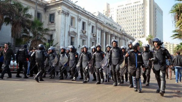 Egypt riot police officials approach protestors outside of a court in Alexandria. The new military trial article that allows civilians to be tried in front of a military court has elicited criticism and protest from many Egyptians as well as regional and international human rights groups (AFP)