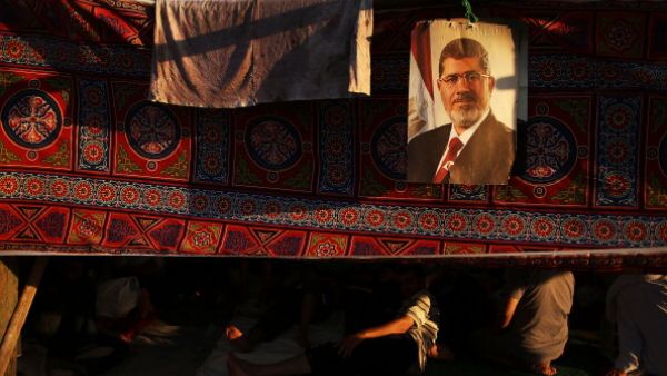 A picture of Mohamed Morsi hangs from a supporter's tent on July 10, 2013. (source: Getty / Spencer Platt)