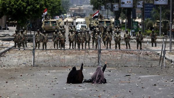 Egyptian women face off with police on July 8, 2013. (source: AFP / MAHMUD HAMS)