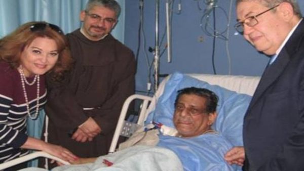Farouk and his family by his bedside in hospital before he passed away. (Image: Facebook)