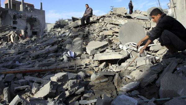 Israeli airstrikes regularly damage Palestinian property severely. Here, Palestinians look at the wreckage of their homes in the Gaza town of Rafah in late 2012. (AFP/File)