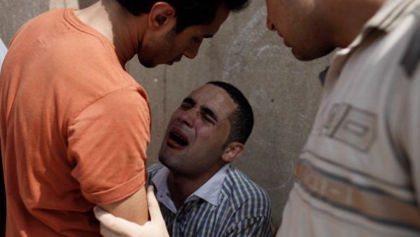 A man mourns after the July 8 shootings near Cairo's Republican Guard club. (source: Ed Giles / Getty)