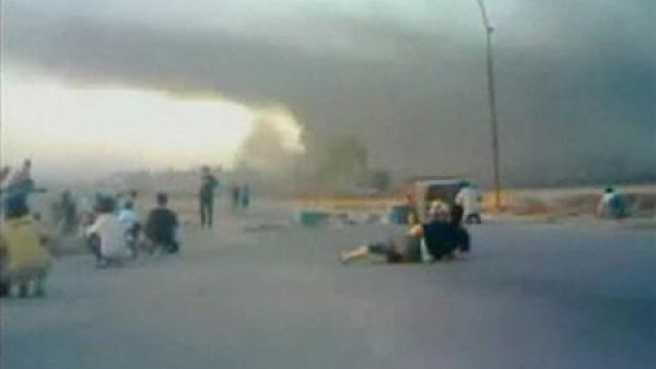  سكان يحاولون تفادي الطلقات النارية في حي بحماة يوم الأحد.
