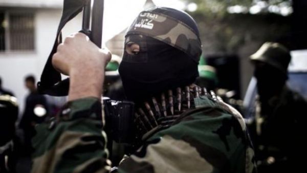 A Hamas member holds a gun during a march.