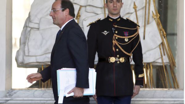 French President Francois Hollande leaves after the weekly cabinet meeting. (Image credit: AFP)