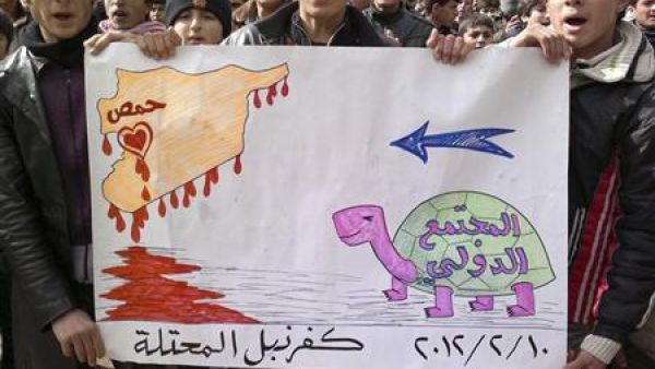 محتجون يرفعون لافتة خلال احتجاج في كفر نبل قرب ادلب 
