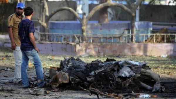  Iraqi men inspect the site of an explosion on September 4, 2013 that took place the previous day in Baghdad. Al Qaeda's Iraqi faction, the Islamic State of Iraq and the Levant, has taken responsibility for the attacks. (AFP)