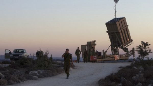 Israeli soldiers stand near an Iron Dome battery, a short-range missile defence system, designed to intercept and destroy incoming short-range rockets and artillery shells, near Jerusalem on Sunday. (AFP)
