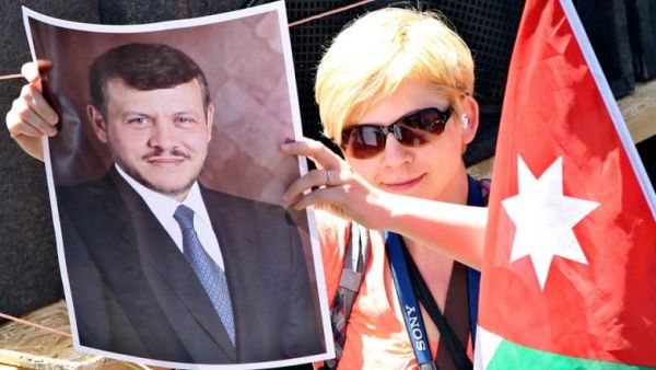 A pro-government supporter holds a picture of Jordan's King Abdullah in Amman in April 2012. (Photo: Muhammad Hamed)