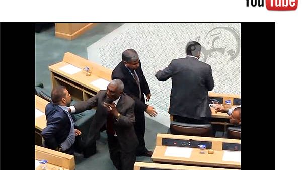 Shady Al-Edwan reaches for his gun during a session of parliament
