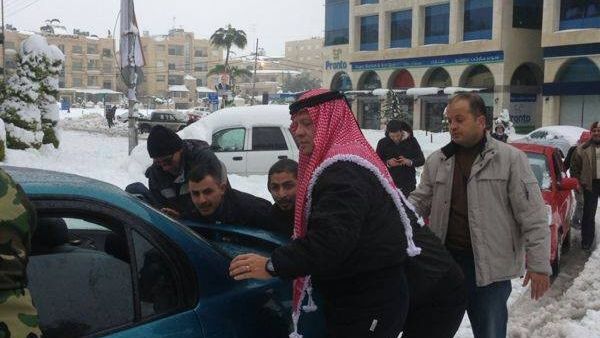 Jordan's King Abdullah went to the streets Saturday to help residents dig their cars out from layers of snow that has trapped many people throughout the Kingdom (Courtesy of Jordan Times)
