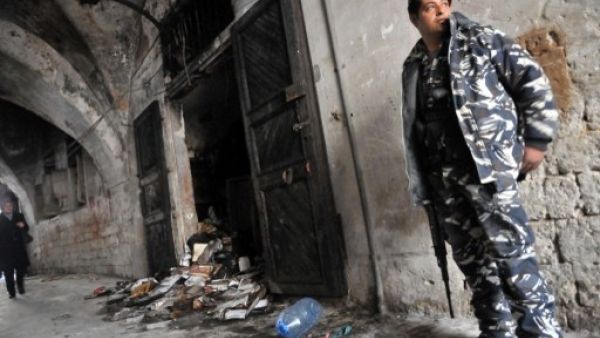 A Lebanese soldier guards the torched library Saturday (Ibrahim Chalhoub/AFP)