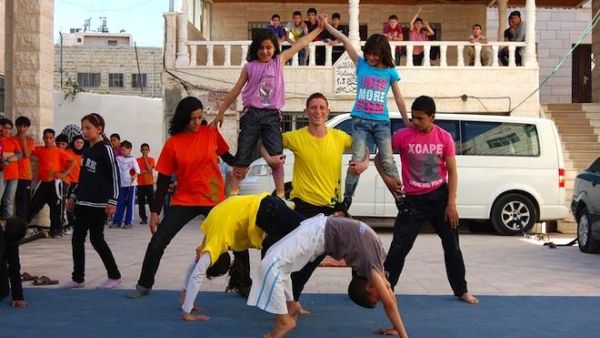 Mohammad, centre in the yellow tshirt, peforms at a Palestinian Circus School open day in Hebron in May 2012. Seven months later, he was killed by the Israeli army. (Photo courtesy of Palestinian Circus School/Your Middle East)