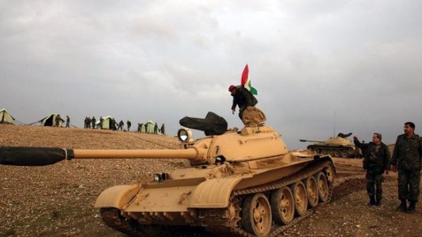 Iraqi Kurdish soldier stands on a tank, flying the Kurdish flag, on Saturday. ( AFP PHOTO / SAFIN HAMED)