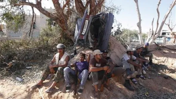 مقاتلو الحكومة الليبية في استراحة يوم الاحد خلال الاشتباكات مع مقاتلين موالين للقذافي في سرت
