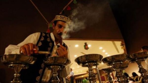 Preparing hookah for customers.