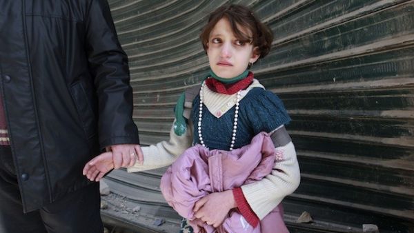 A poor, young Syrian girl is in tears as she is escorted off by her new "husband". (image courtesy of takepart.com)