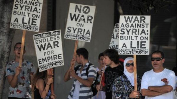 People demonstrate against a US-led strike on Syria in downtown Los Angeles on August 31, 2013. (AFP) People demonstrate against a US-led strike on Syria in downtown Los Angeles on August 31, 2013. (AFP)