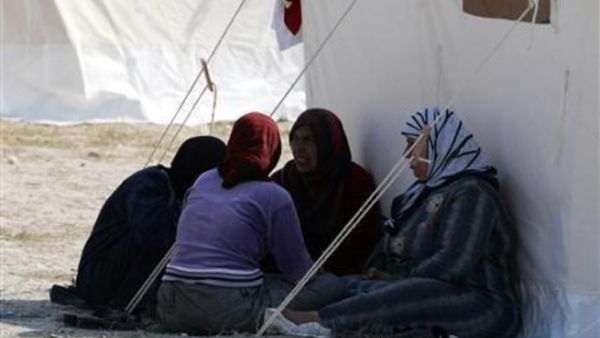 سوريات يجلسن في مخيم للنازحين السوريين في بلدة باقيلم هاتاي التركي على الحدود مع سوريا