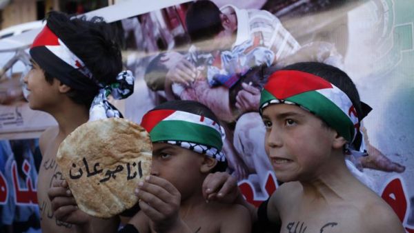 Dozens of Yarmouk residents are dying from hunger - according to activists, they've been surviving on a diet of stale vegetables, herbs, powdered tomato paste, animal feed and cooking spices dissolved in water. (AFP/File)