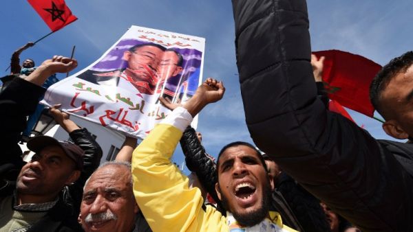 This file photo taken on March 13, 2016 shows Moroccan protesters holding placards and shouting slogans in the capital Rabat, during a demonstration against statements made by the United Nations chief earlier in the week regarding the Western Sahara, a disputed territory between Morocco and the Polisario Front, following his visit to a camp for refugees from the territory. (AFP/Fadel Senna)