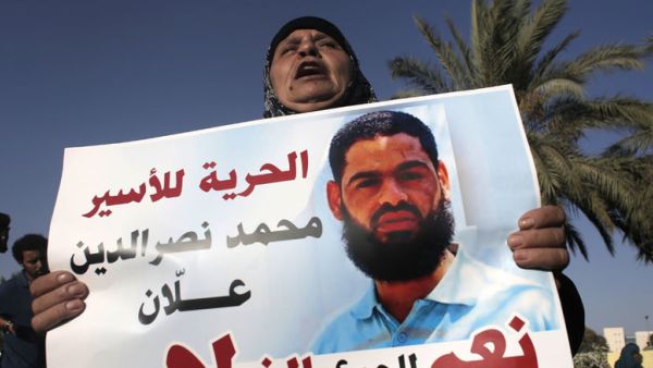 Maazouze, the mother of Muhammad Allan, a Palestinian prisoner who is on a long-term hunger strike, holds a portrait of her son during a rally calling for his release in the southern Israeli city of Beersheva on August 9, 2015. (AFP/Ahmad Gharabli)
