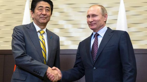 Russian President Vladimir Putin (right) shakes hands with Japanese Prime Minister Shinzo Abe during a meeting on the sidelines of the Eastern Economic Forum. (AFP/ File)