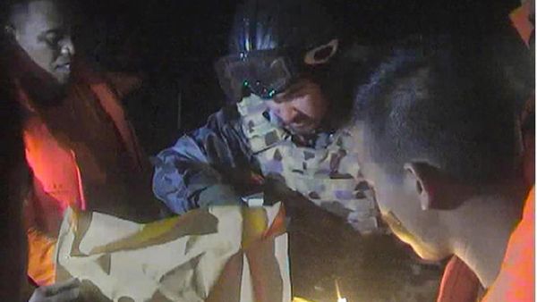Members of the Australian navy look for survivors from a boat carrying Middle Eastern asylum seekers. At least 22 people have died, most of them children. (Image credit: AFP)