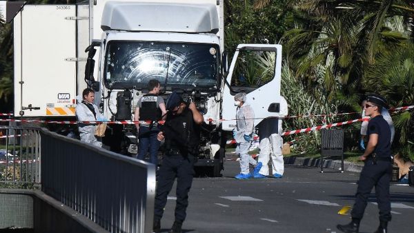 French police and security forces examine the remains of the delivery truck that Mohamed Lahouaiej Bouhlel drove into a crowd of people on Bastille Day. (AFP/File)
