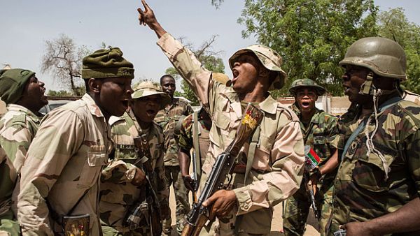 Nigerian troops celebrate after taking over the town of Bama from Boko Haram. (AFP/Nicole Sobecki)
