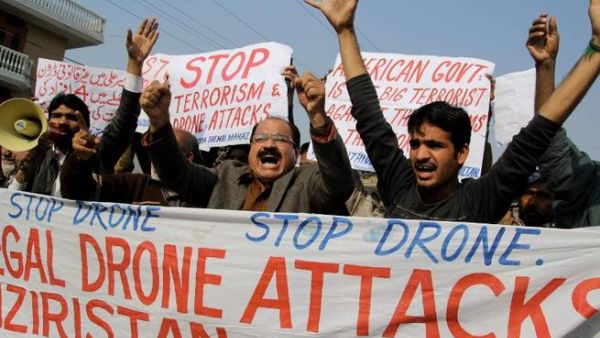 Activists from the Muttahida Shehri Mahaz shout slogans as they protest against a US drone attack in Multan on December 26, 2103. [AFP]