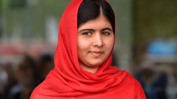 Photo taken on September 3, 2013 shows Malala Yousafzai, the 16-year-old Pakistani advocate for girls education who was shot in the head by the Taliban in 2012, opening the Library of Birmingham. (Image credit: AFP)
