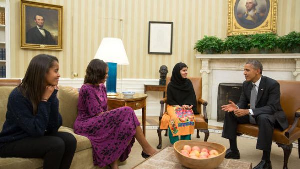 This official White House photo shows President Barack Obama, First Lady Michelle Obama, and their daughter Malia meet with Malala Yousafzai, the young Pakistani schoolgirl who was shot in the head by the Taliban a year ago. (Image credit: AFP)