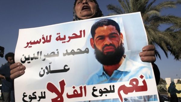 The mother of Mohammed Allaan, a Palestinian prisoner who was on a long-term hunger strike, holds a portrait of her son during a rally calling for his release on August 9, 2015. (AFP/ Ahmad Gharabli) The mother of Mohammed Allaan, a Palestinian prisoner who was on a long-term hunger strike, holds a portrait of her son during a rally calling for his release on August 9, 2015. (AFP/ Ahmad Gharabli)